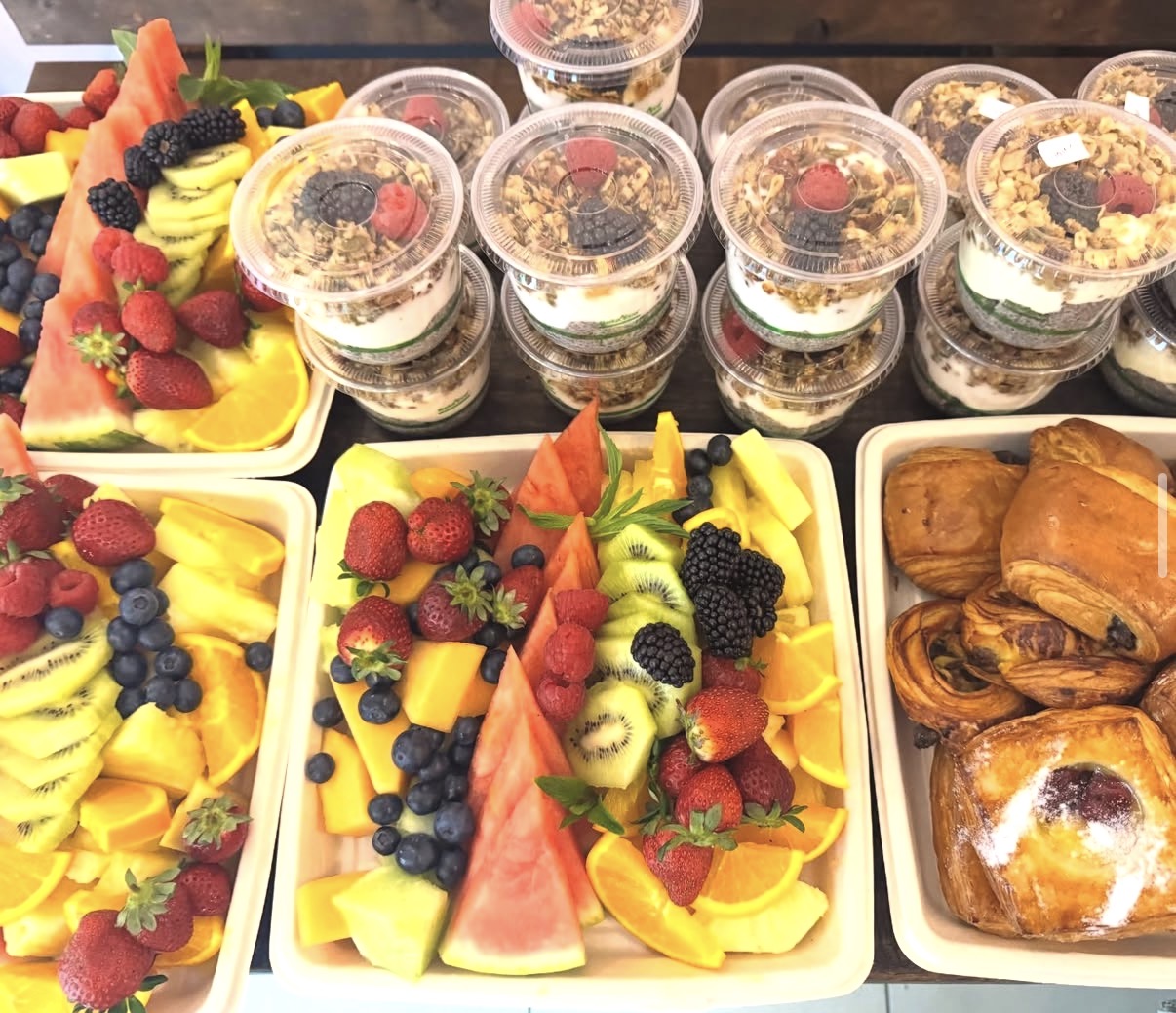 Fruit salad cups, yogurt pods and pastries at the counter