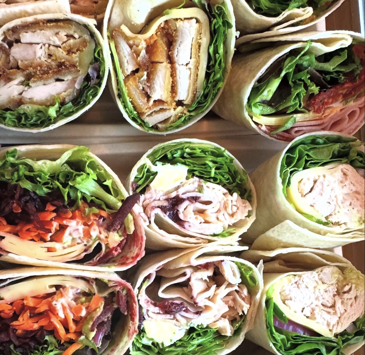 Fresh salad wraps cut and stacked on a tray